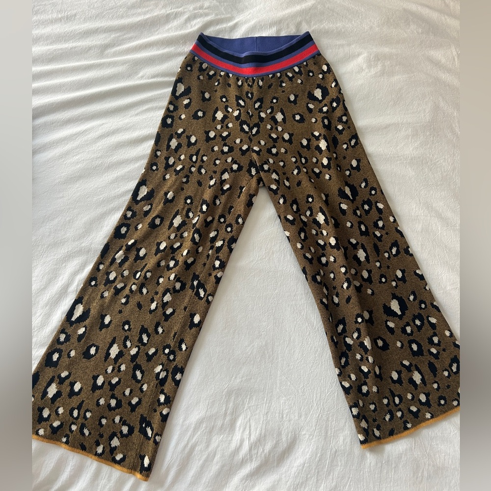 Dolan cropped leopard print pants 🐆 with red blue and black striped waistband.